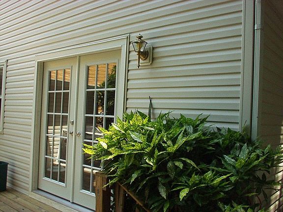 French doors leading from kitchen to side deck 
