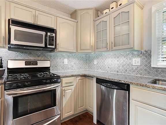 Look at the detail in the tile blacksplash! Gorgeous granite counters.  Gleaming hardwoods.  Everything done to perfection.