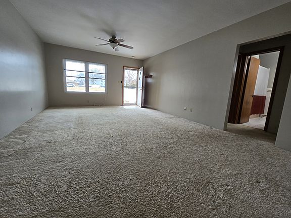 living room with newer windows and new carpet