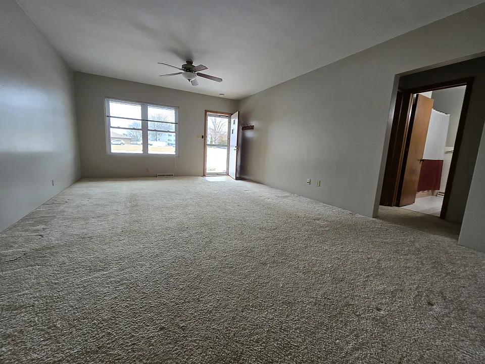 living room with newer windows and new carpet