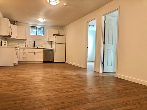 Open-concept kitchen flows into two bedrooms