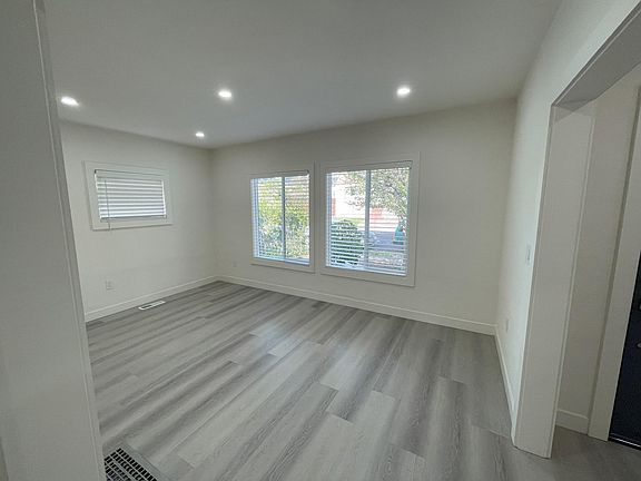 Living Room inside the house. The 2 large windows are facing the front yard and Pomona Ave.