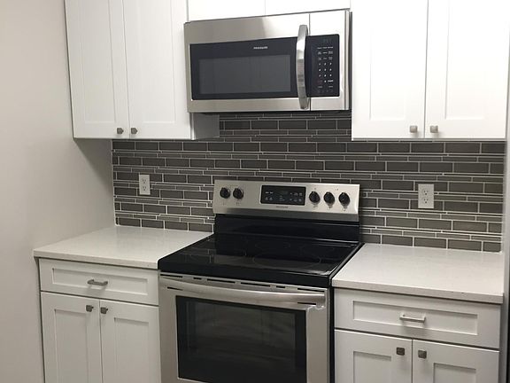Kitchen offers stainless steel appliances and quartz countertops.