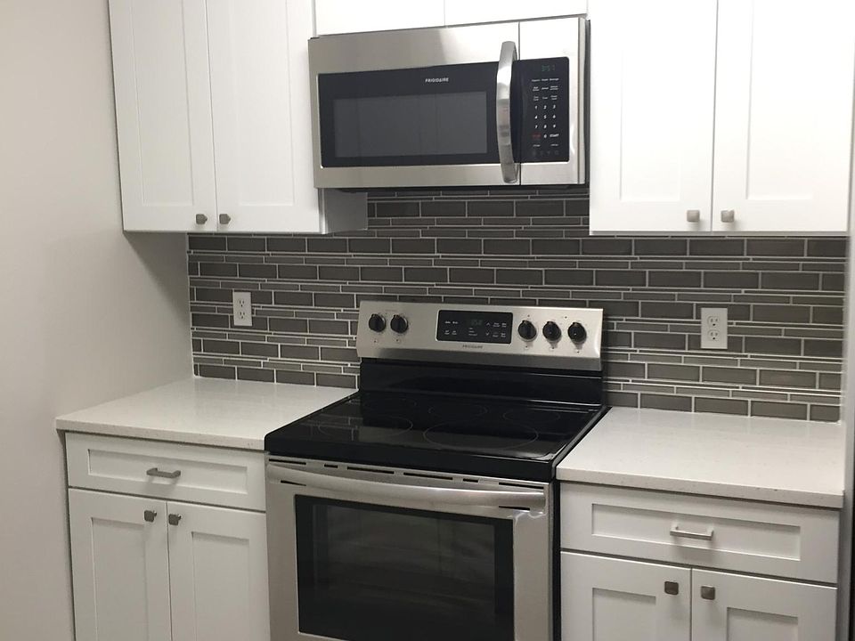 Kitchen offers stainless steel appliances and quartz countertops.
