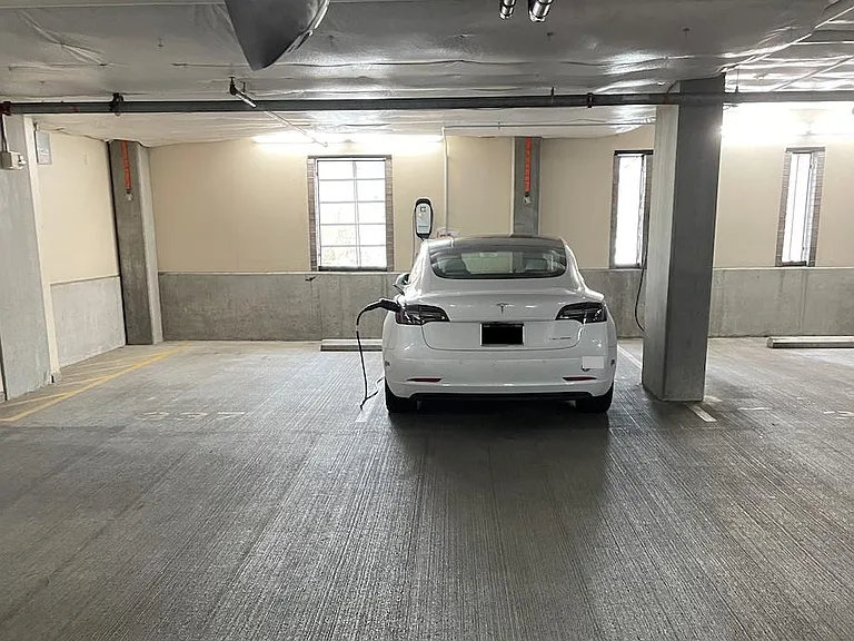 One deeded parking space within the building's gated parking garage. Private OpConnect Charger for EV charging.