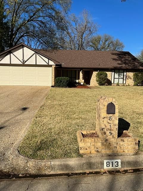 Front of house. Brick mailbox with planters.
