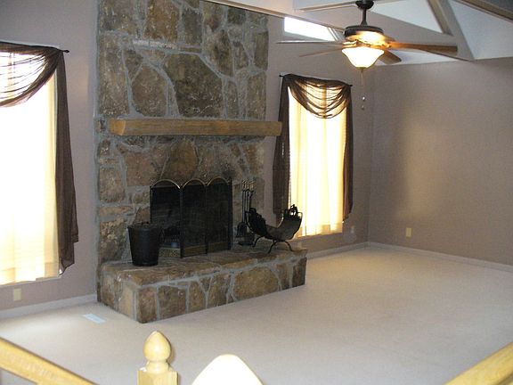 great room with cathedral ceilings and wood burning fireplace