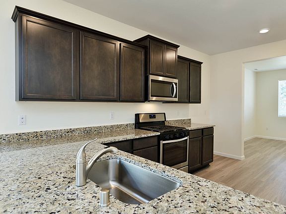 Everyone will enjoy gathering at the long breakfast bar in this modern, upgraded kitchen.