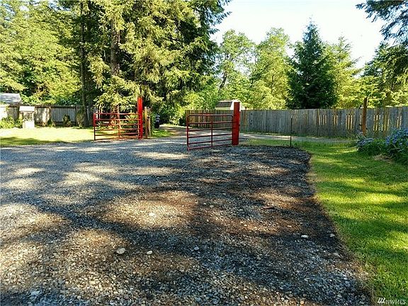 This custom built red gate greets you to your fully fenced playground!