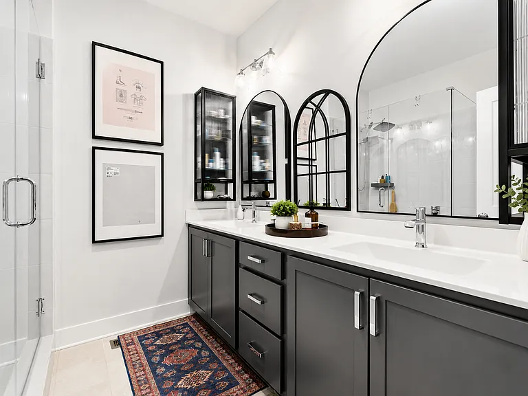En suite bathroom for main bedroom with upgraded his/her mirrors and storage