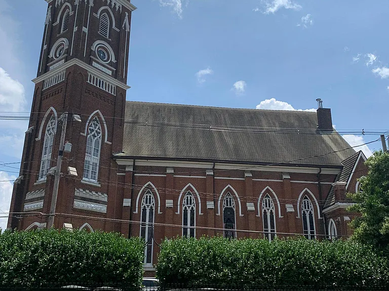 Yard has church tower view.