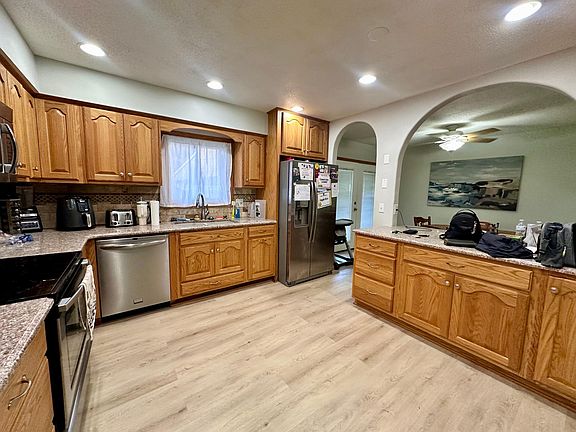 An elegant kitchen with built-in custom made cabinets, granite countertop, lot of space with built-in pantry, soft close and newer SS appliance, new floor