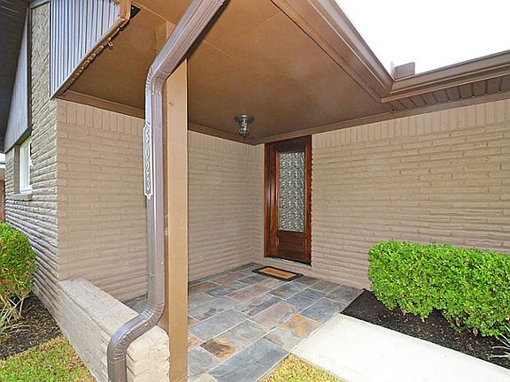 Your guests are sure to be impressed with this shaded front porch entry with slate tile floor and ne