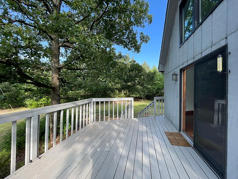 part of the deck off the side of the house, facing the pond. Great for grill, outdoor furniture.