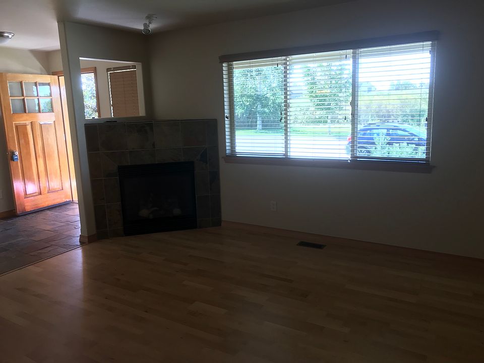 LOOKING AT GAS FIREPLACE INTO TILED FOYER