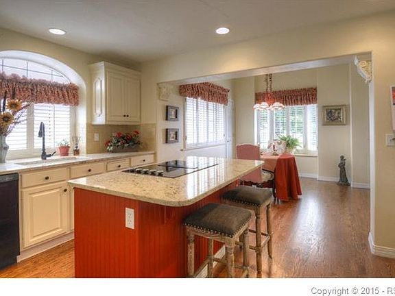 Corbels grace the transition from kitchen to hearth room
