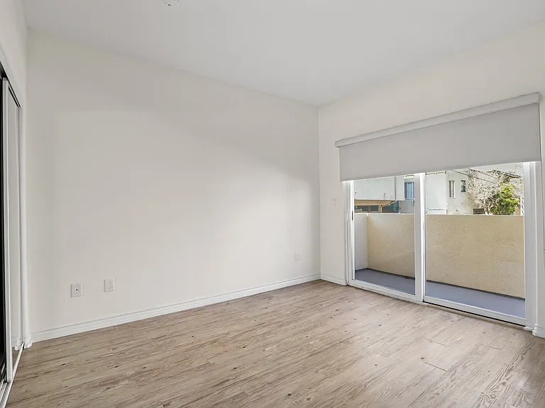 Spacious Bedroom with Mirrored Closet and Private Balcony