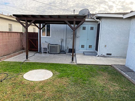 Small covered patio, outdoor sink and water softener closet