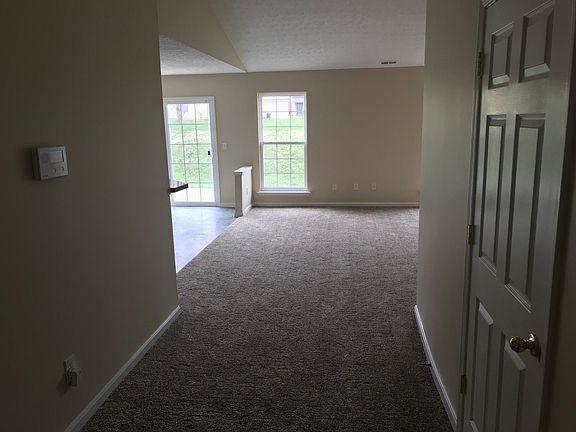 Recessed foyer entry to high vaulted ceilings