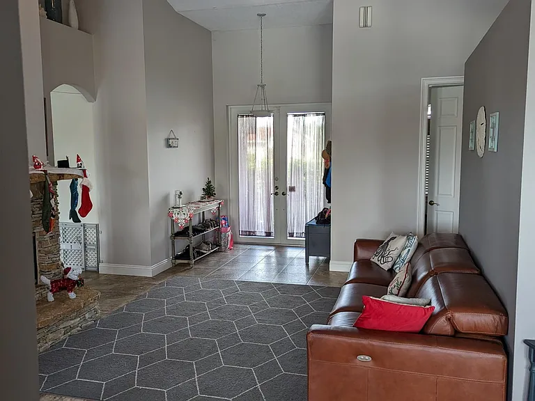 Grand entry, view from dining nook toward front door. For layout perspective, the laundry room door is visible to the right of the front door.