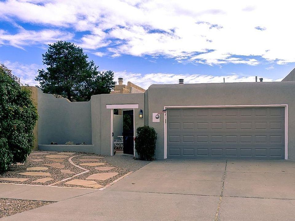 This newly stuccoed home features a 2-car garage and gated courtyard.