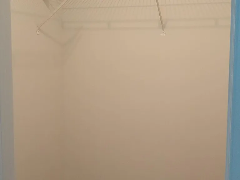 walk-in closet in secondary bedroom