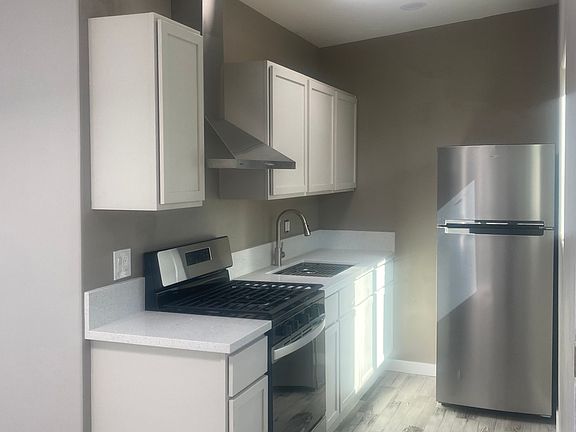 Kitchen - new tile floors, maple cabinets, quartz countertops, stainless steel appliances and gas stove