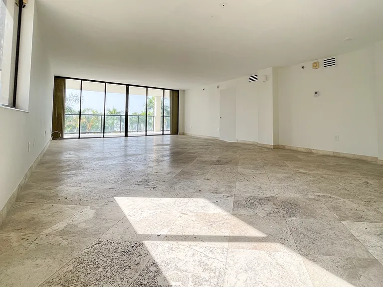 Updated details from frameless solid wood doors to modern AC vents complement the expansive living room making it a great hosting space.