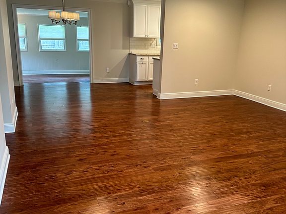 View from front door into family room, dining area, entrance to kitchen, and sunroom