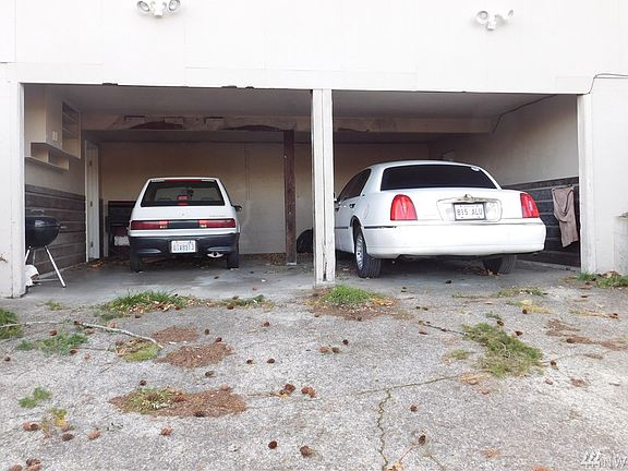 There is a carport for each unit.  Access is through an alley.  Each unit has a door from the Carport to the walkout basement.  There is also a gate to the back yards.  Each unit has their own backyard.