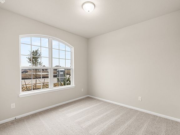 Your secondary bedroom features plush carpet, fresh paint, closet, and a large window that lets in p
