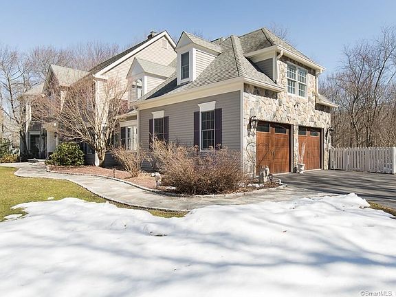 Stonework, updated garage doors and custom walk-way create and inviting and dramatic entrance.