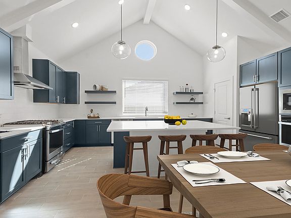 Kitchen with pendant lighting and vaulted ceiling