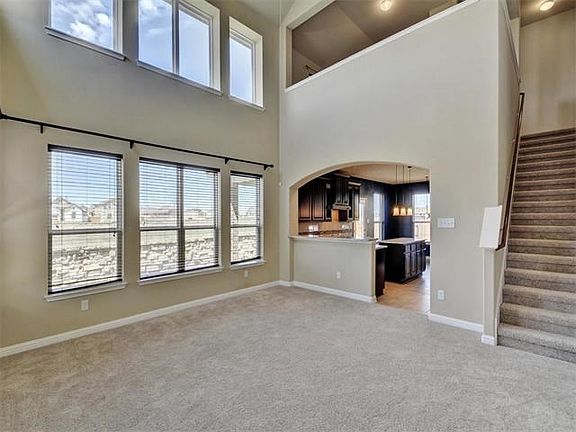 Soaring 2-story living room with large picture windows.