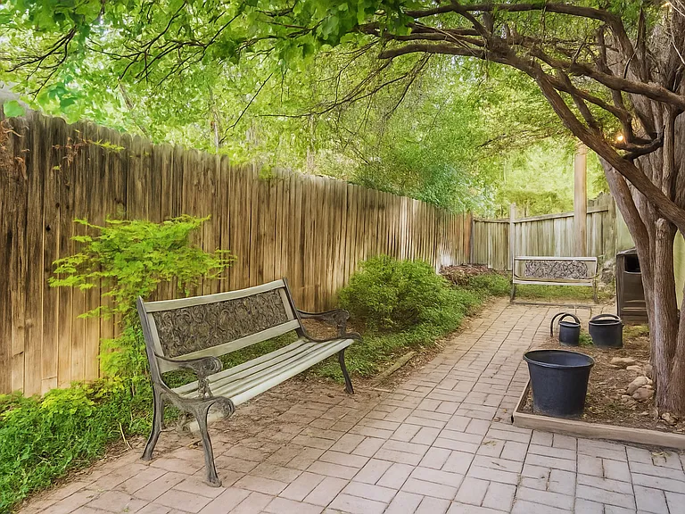 Tucked beneath a canopy of trees, this quiet outdoor nook is perfect for morning coffee, journaling, or simply unwinding with a good book. A peaceful little escape just steps from your door.