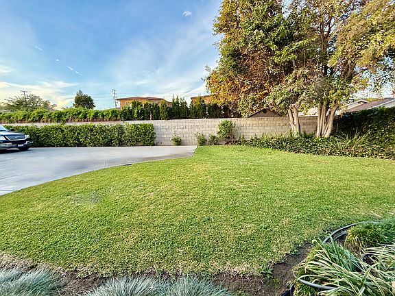 look at this pretty view from the front door! Attractive landscaping, open space, and in the distance you can actually see the mountians!