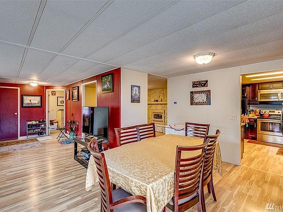 Looking back on the entrance from the dining room.  The closed left door is hall closet.  The open door in the center is an office/hobby room.  The family room fireplace can be seen mid-picture.  The kitchen entry is to the right. 