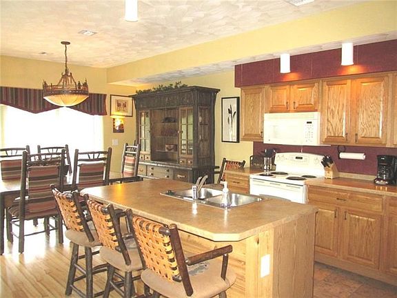This shot allows you to see into the dining area. The extended countertop on the kitchen island allows for a quick bite to eat o