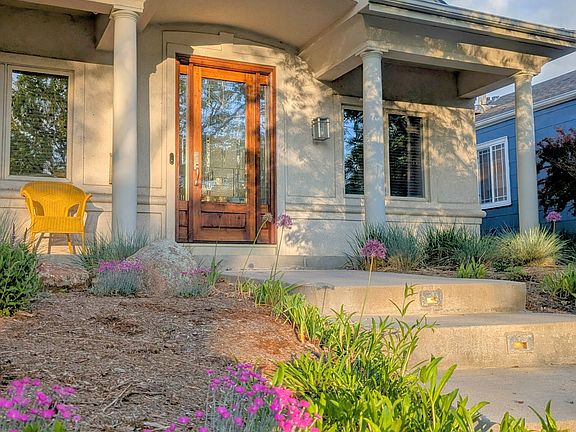 professional lanscaping and stained glass front entry door.