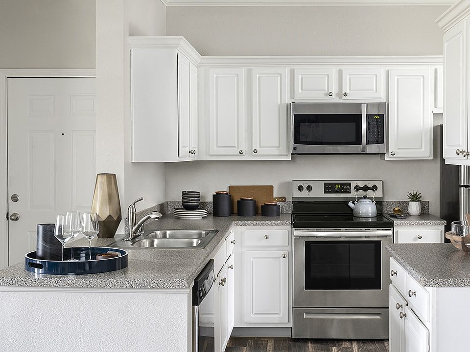 Apartment Kitchen with Stainless Steel Appliances, granite counters and wood floors.