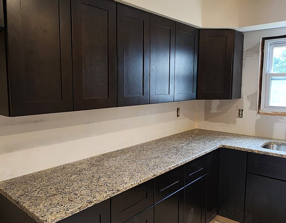 Brand new kitchen with soft close modern shaker cabinets and stone countertop. There will be a stainless chimney on top of gas range.