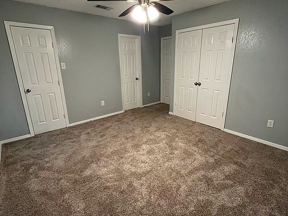 Spacious master bedroom featuring a walk-in closet and an additional full-sized closet for ample storage.