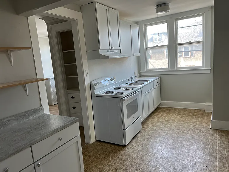 kitchen has new appliances (refrigerator and stove )
