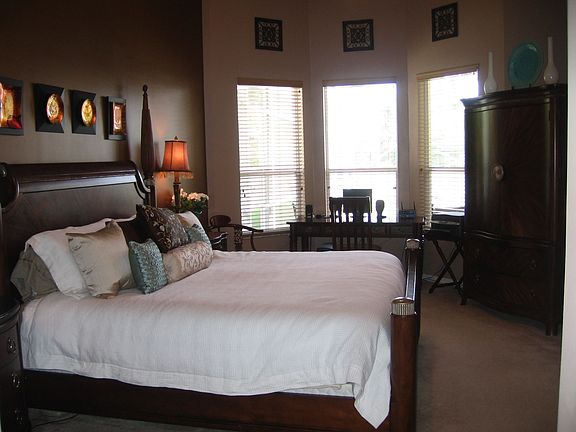 Spacious master bedroom with tray ceiling and two walk in closets.