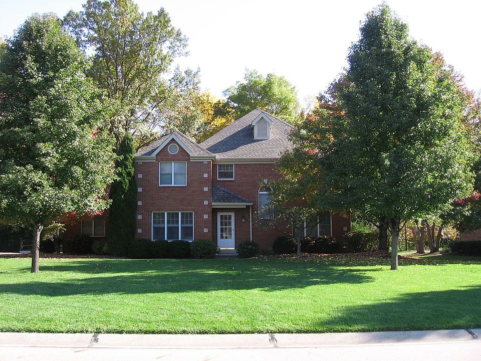 All brick home with mature trees and side entry garage.