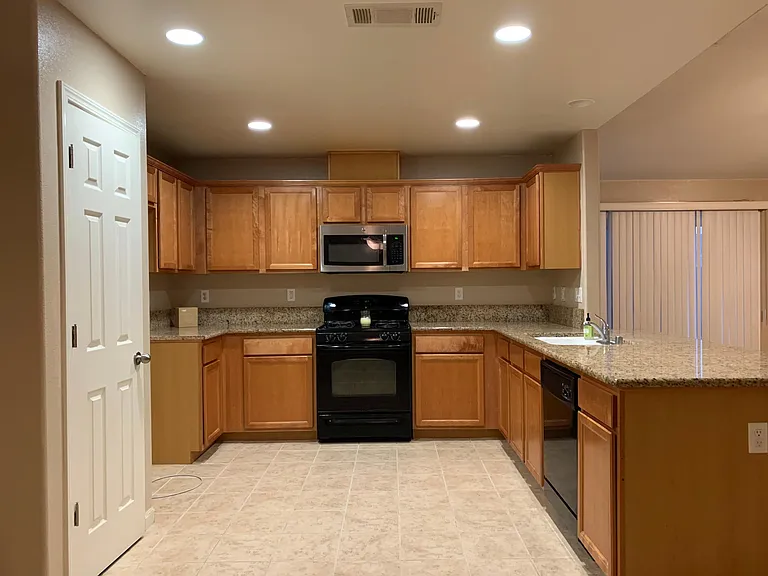 Kitchen with spacious cabinets and easy to clean granite tops.