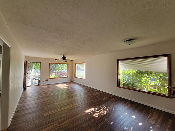 Dining Room & Living Room with 3 big picture windows and it opens into kitchen.