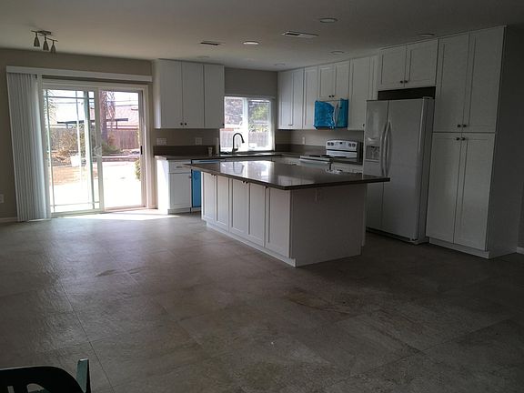 Another kitchen view with sliding door and pass-through window.