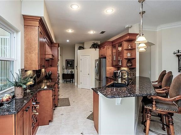 Kitchen Features Wood Cabinetry & Granite Counters