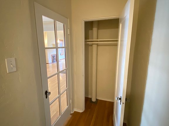 HALL CLOSET AND DOOR SEPARATING DINING AND LIVING ROOM FROM REST OF UNIT
